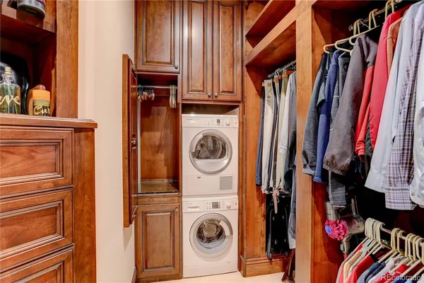 a view of walk in closet with clothes