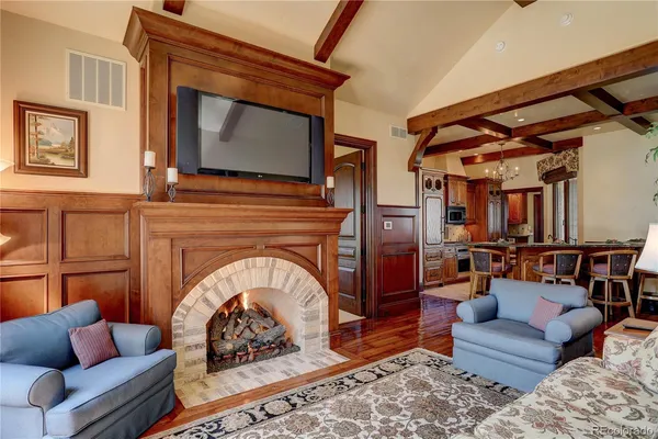 a living room with furniture a fireplace and a flat screen tv