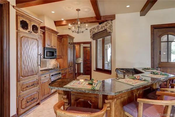 a kitchen with stainless steel appliances granite countertop a stove and a refrigerator