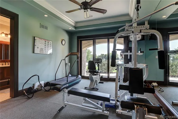 a room with gym equipment and large mirror