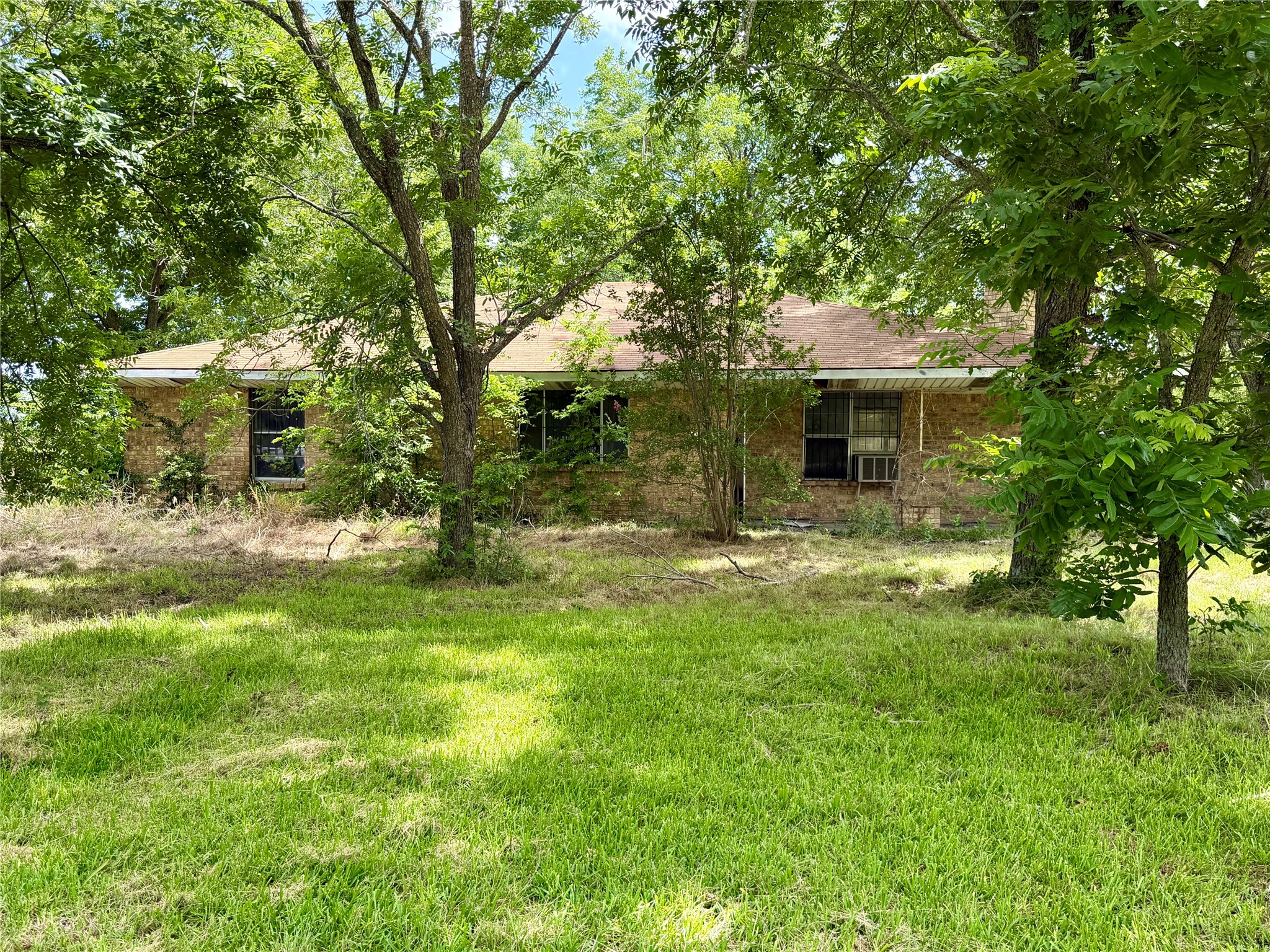 2501 Barnhardt Road Temple, TX 76502 - Photo 2 of 25 A classic brick exterior blends with lush surrounding trees, offering natural privacy and a timeless appeal.