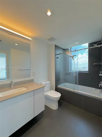 a bathroom with a tub a sink and a toilet