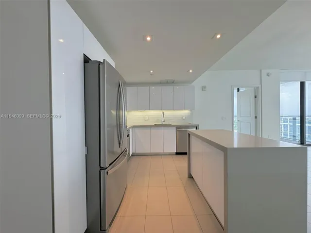 a view of a kitchen with a sink and cabinets