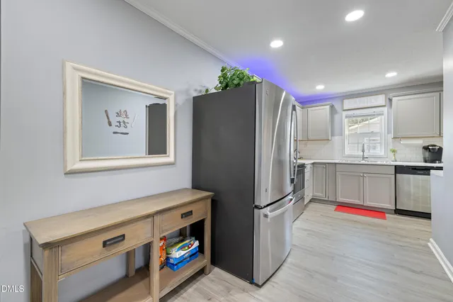a kitchen with stainless steel appliances a refrigerator and a stove top oven