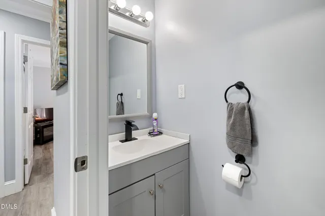 a bathroom with a sink vanity and mirror
