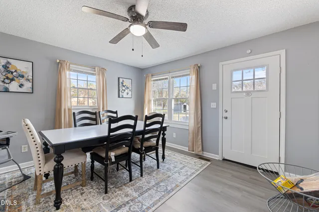 a view of a dining room with furniture window and wooden floor
