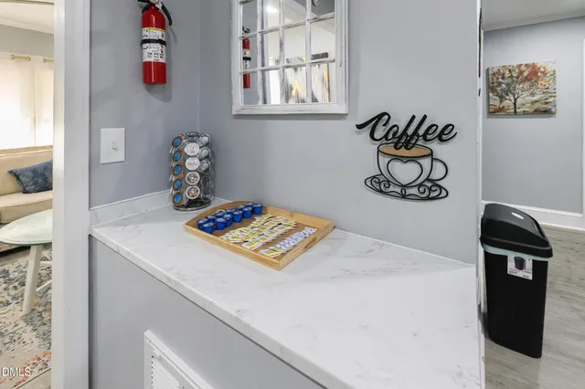 a hallway with a view of kitchen and living room