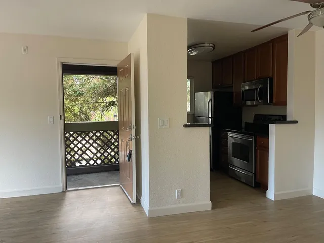 a view of a kitchen from a hallway
