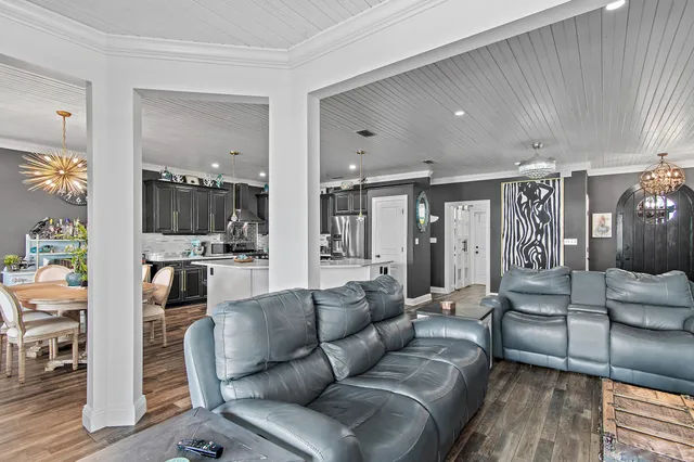 a kitchen with stainless steel appliances granite countertop a sink a stove and a wooden floors