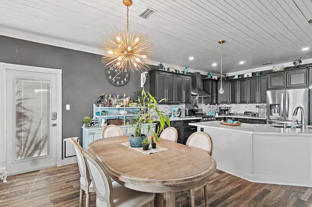 a kitchen with kitchen island a sink stainless steel appliances and cabinets