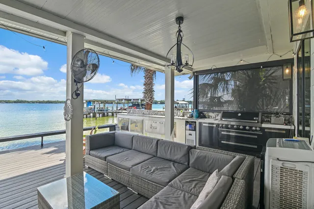 a view of balcony with wooden floor and seating