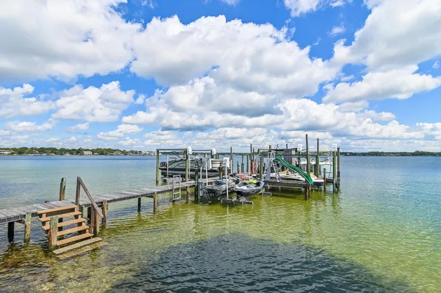 a roof deck with table and chairs