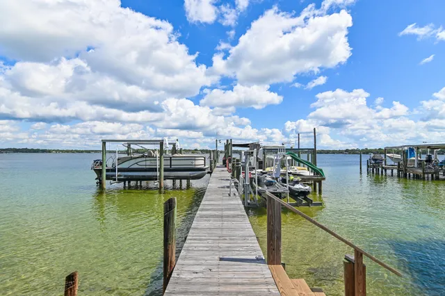 a view of house with deck and outdoor seating
