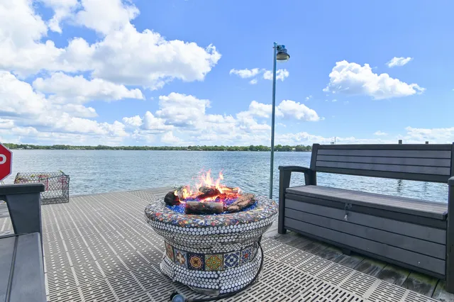 a spacious bedroom with a bed and a large window with balcony view