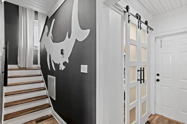 a bathroom with a bathtub and a chandelier