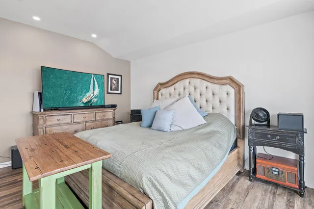 a bathroom with a granite countertop sink a toilet and a mirror