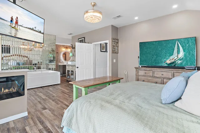 a bedroom with a bed and a flat screen tv