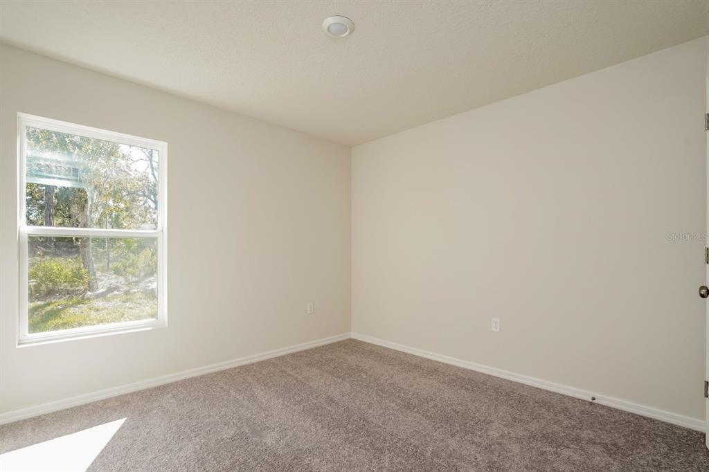 2660 West Bravura Drive Citrus Springs, FL 34433 - Photo 8 of 14 an empty room with a window