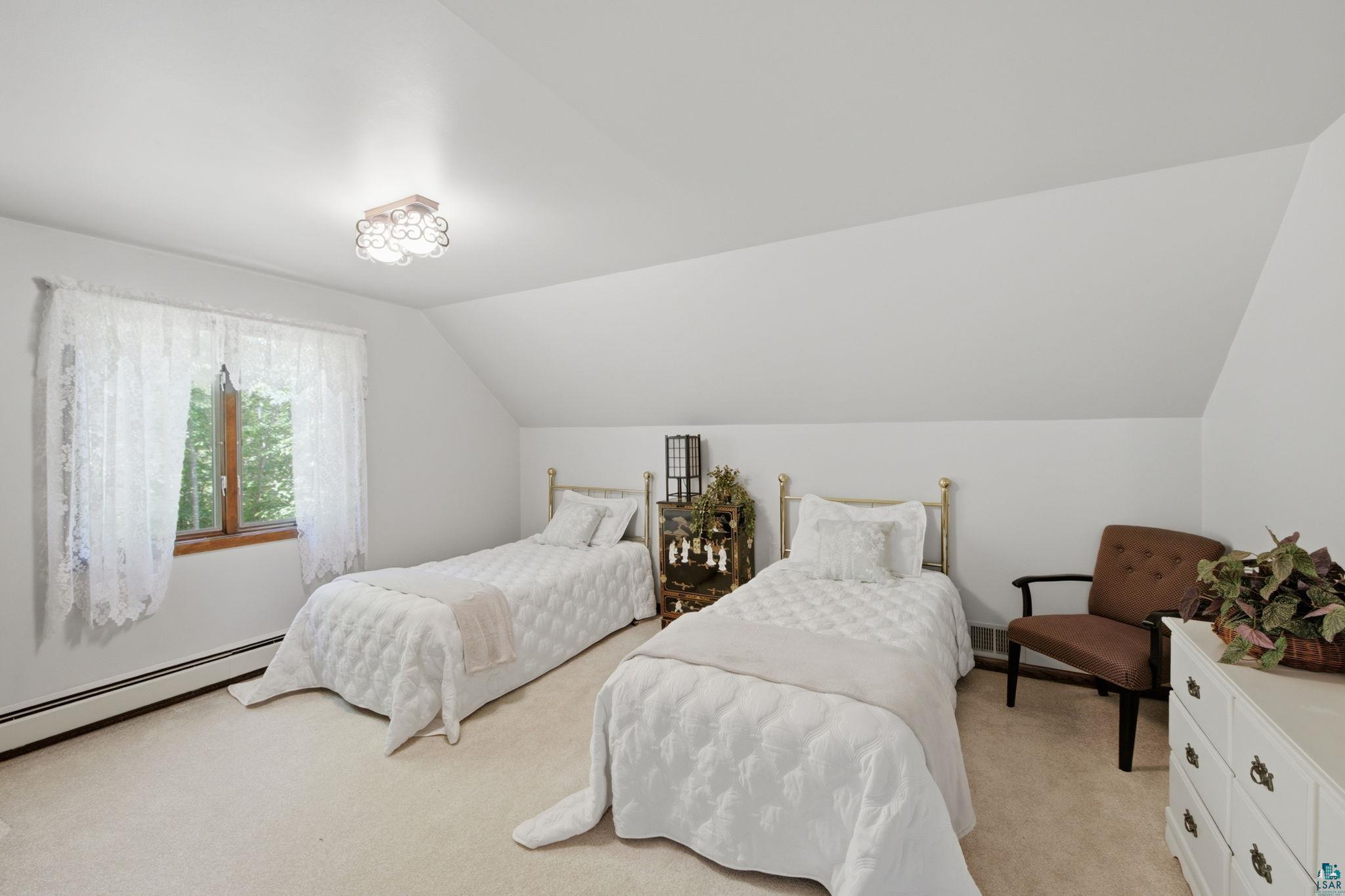27485 South Kane Road Ashland, WI 54806 - Photo 14 of 35 Attic room featuring a sloped ceiling, light-toned carpeting, and a single window with wood trim