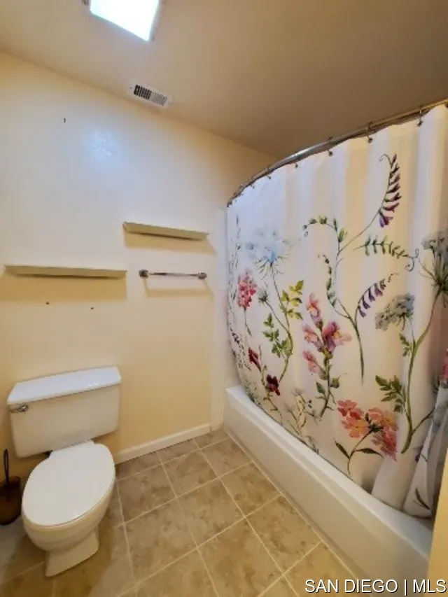 5984 Palencia Drive Riverside, CA 92509 - Photo 11 of 16 a bathroom with a toilet and a shower curtain