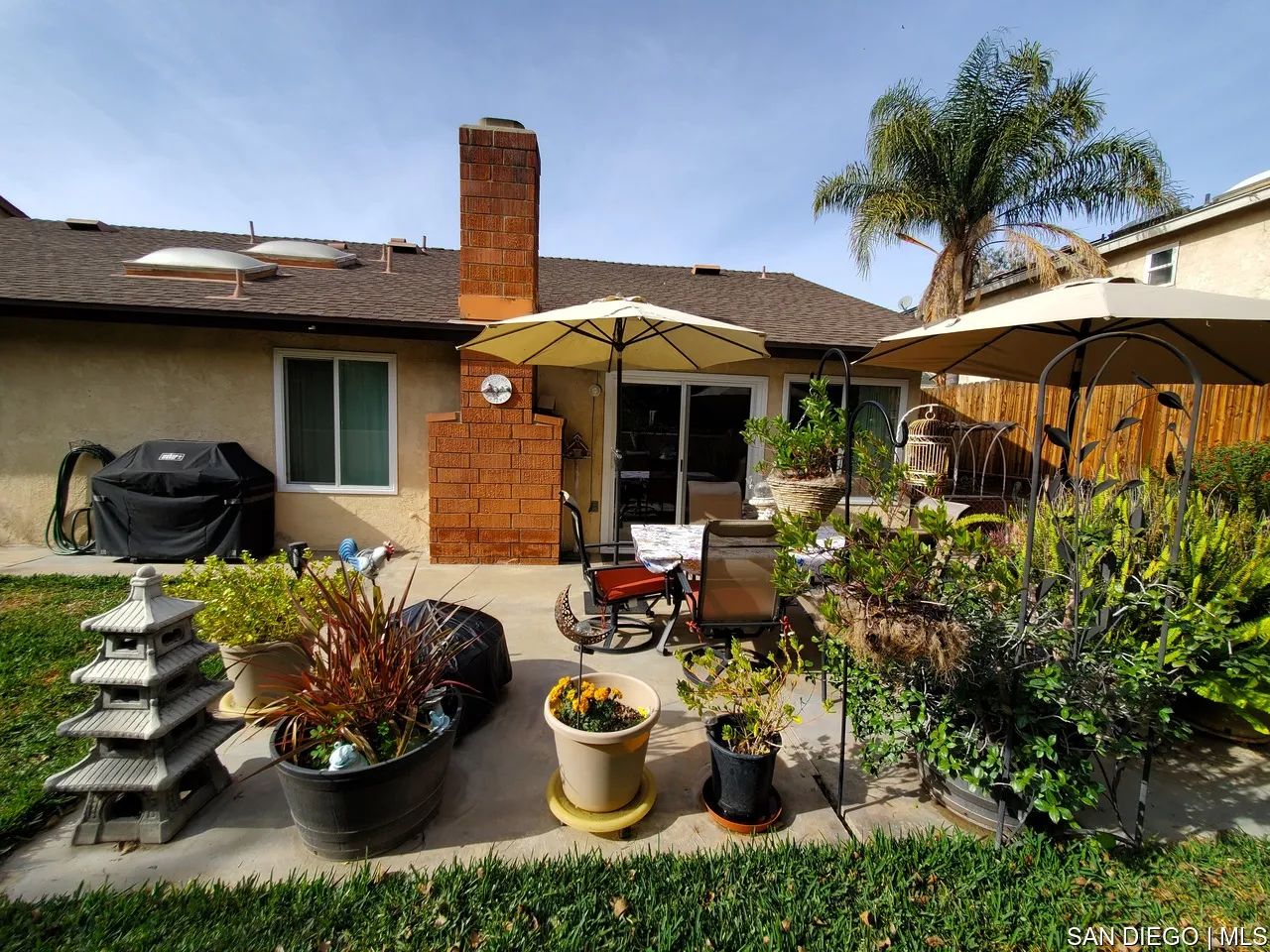 5984 Palencia Drive Riverside, CA 92509 - Photo 2 of 16 a view of a chair and tables in patio along a garden