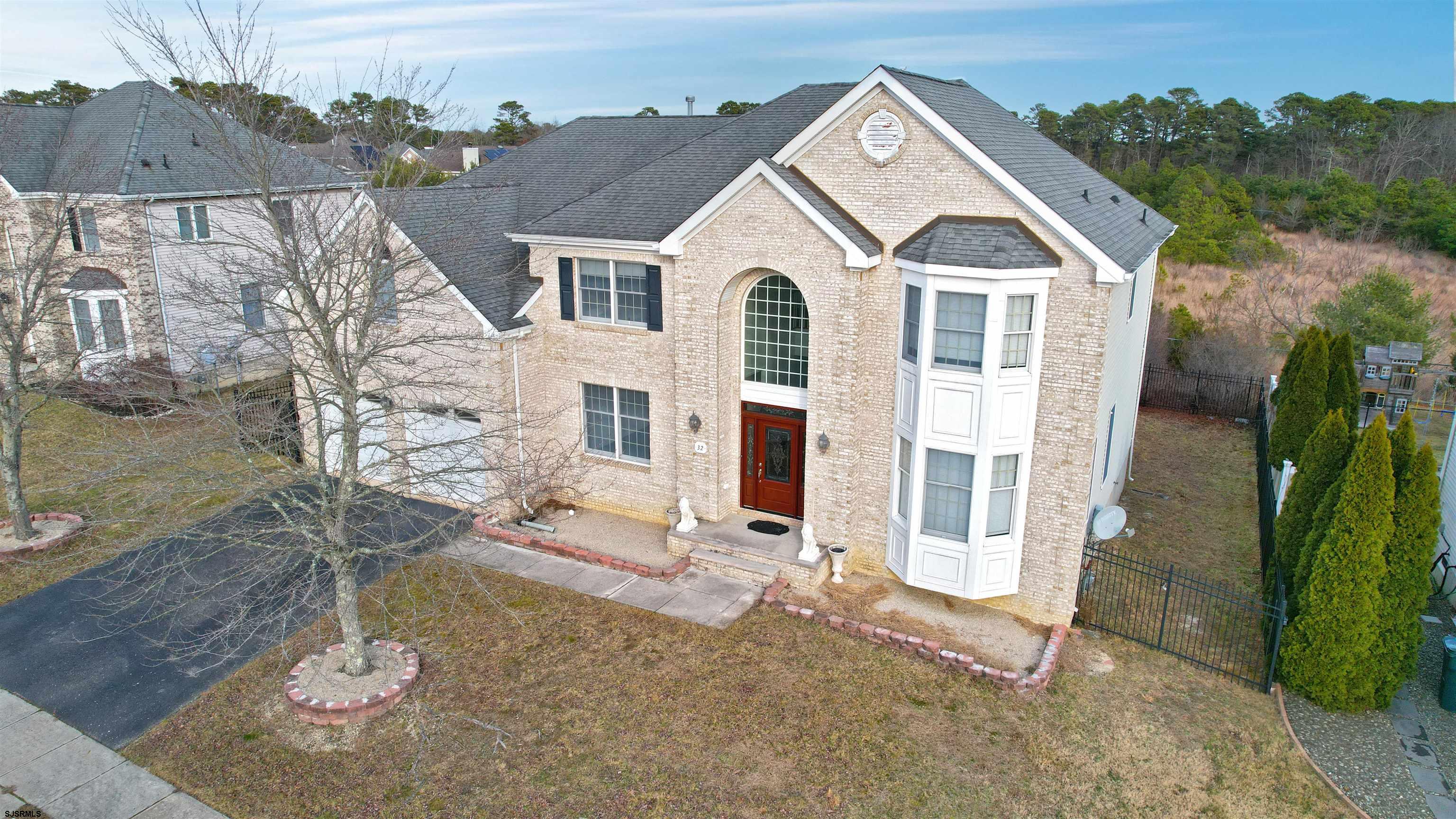 32 Vicari Way Tuckerton, NJ 08087 - Photo 1 of 1 a view of a white house with large windows and a yard