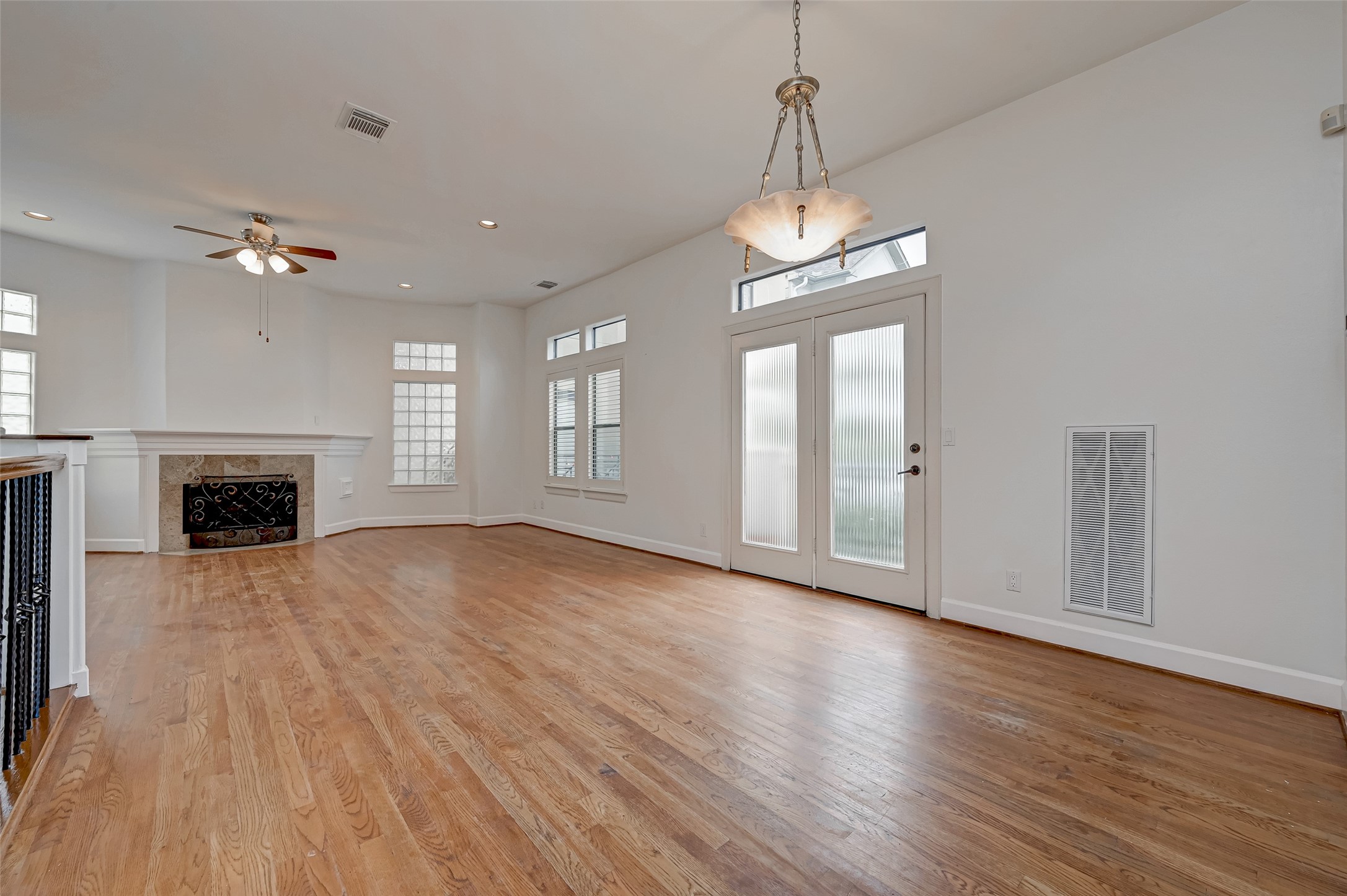 5410 Rose Street Houston, TX 77007 - Photo 13 of 41 an empty room with wooden floor fireplace and windows