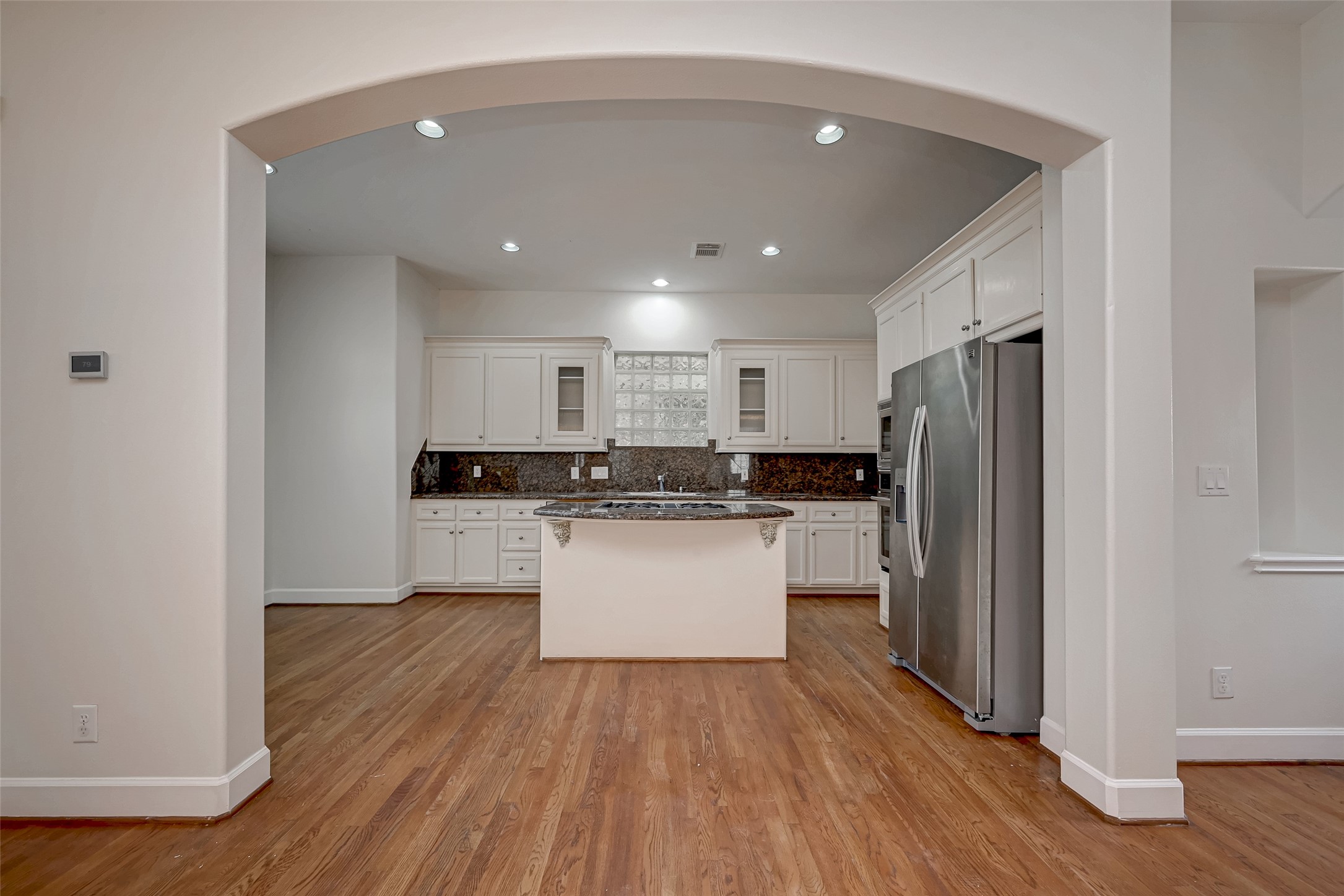 5410 Rose Street Houston, TX 77007 - Photo 17 of 41 a kitchen with a refrigerator and white cabinets