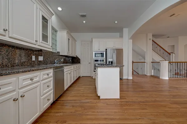 a kitchen with counter top space and cabinets