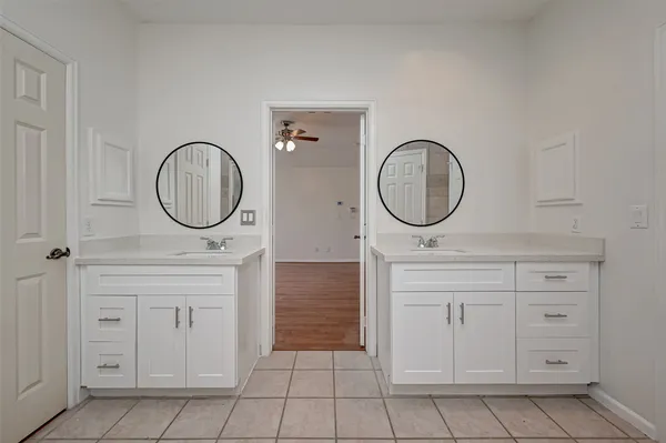 a bathroom with a sink a mirror and a mirror