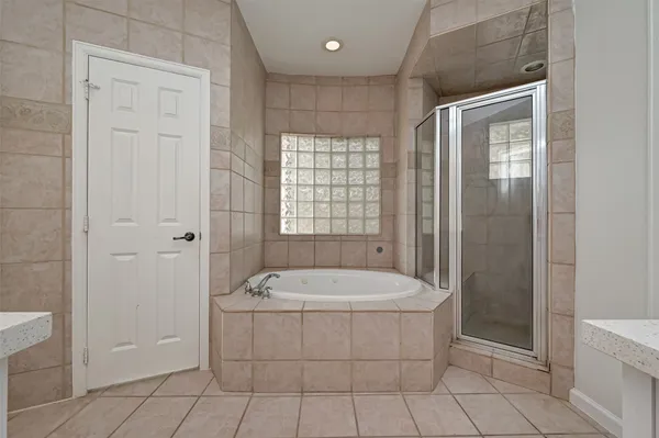 a bathroom with a sink a bathtub and window