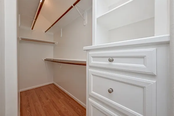 a view of hallway with wooden floor