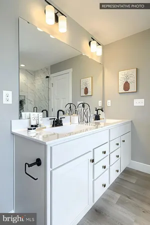 a bathroom with double sink and a mirror