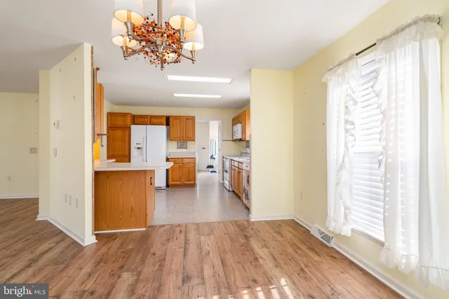 a large kitchen with stainless steel appliances granite countertop a sink and cabinets