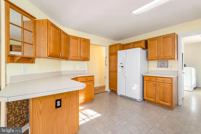 a kitchen with a stove top oven sink and cabinets