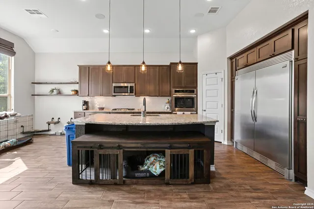 a kitchen with a refrigerator and a fireplace