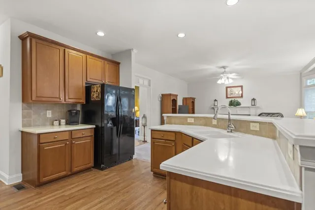 a large kitchen with stainless steel appliances granite countertop a stove and a sink
