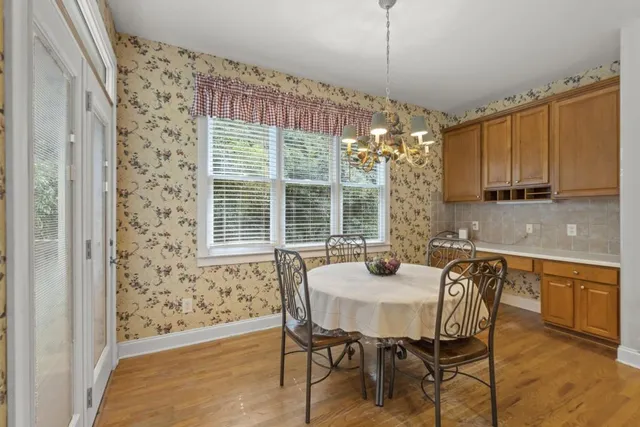 a view of a dining room with furniture window and wooden floor