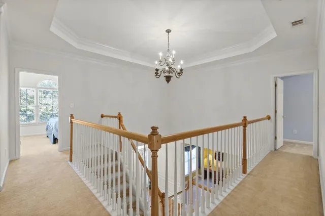 a bedroom with a large bed and a chandelier