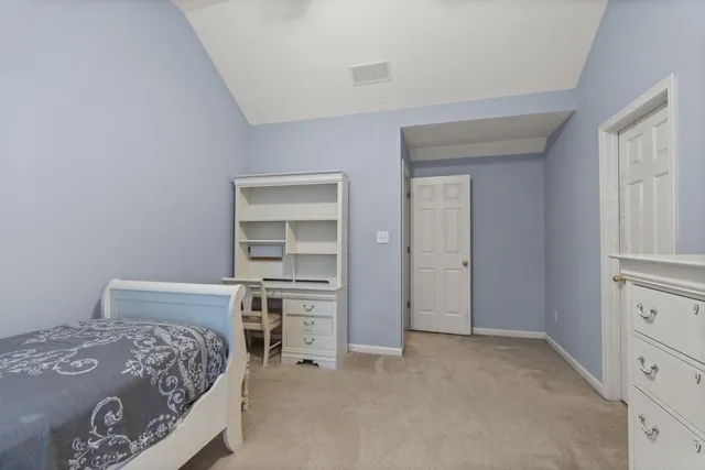 a bedroom with a bed and a television