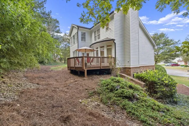 a view of a backyard with large trees