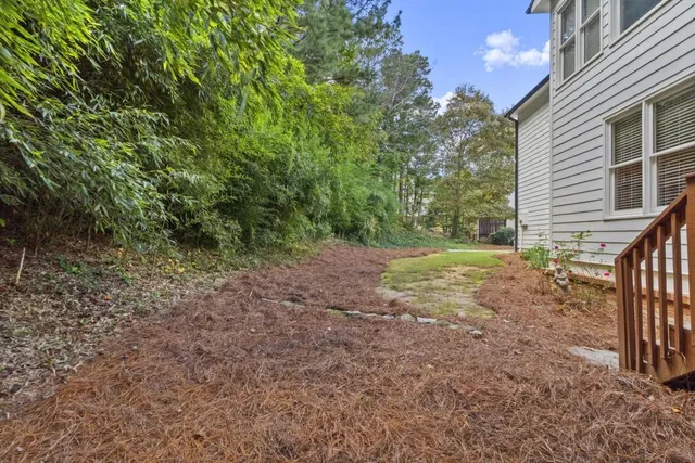 a view of a house with a yard and garage