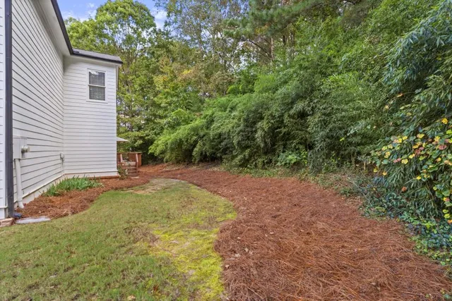 a view of a house with a yard and plants