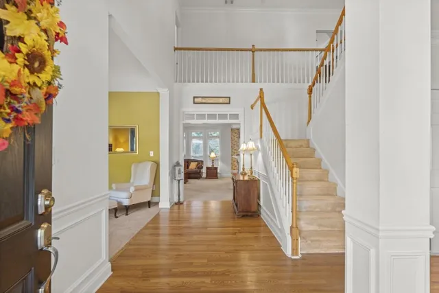 a view of entryway and hall with wooden floor