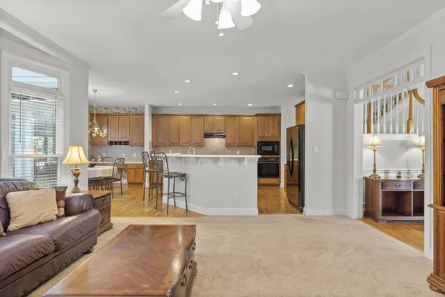 a living room with furniture a fireplace and a large window
