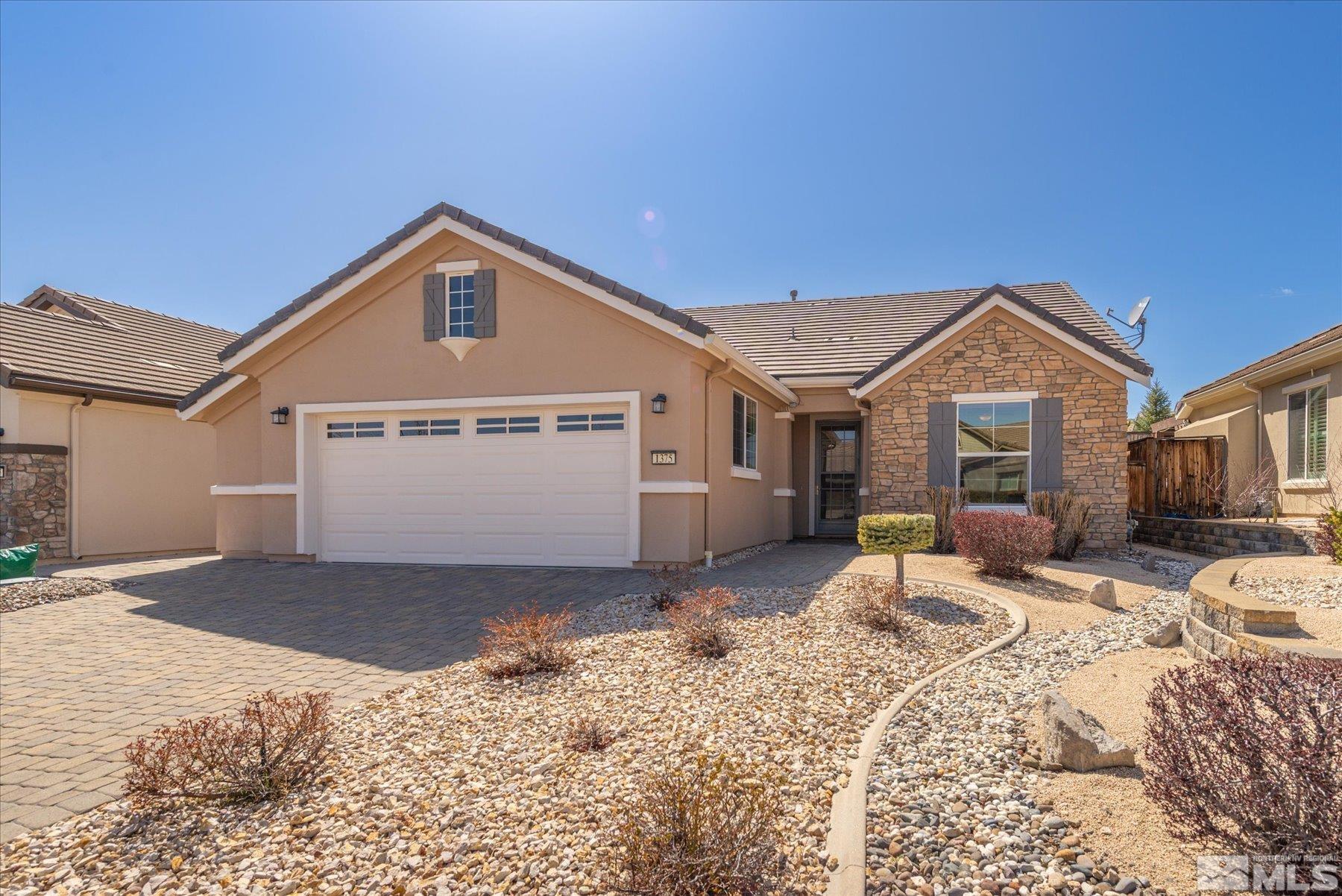 1375 Walking Stick Way Reno, NV 89523 - Photo 1 of 39 a front view of a house with a yard covered in snow