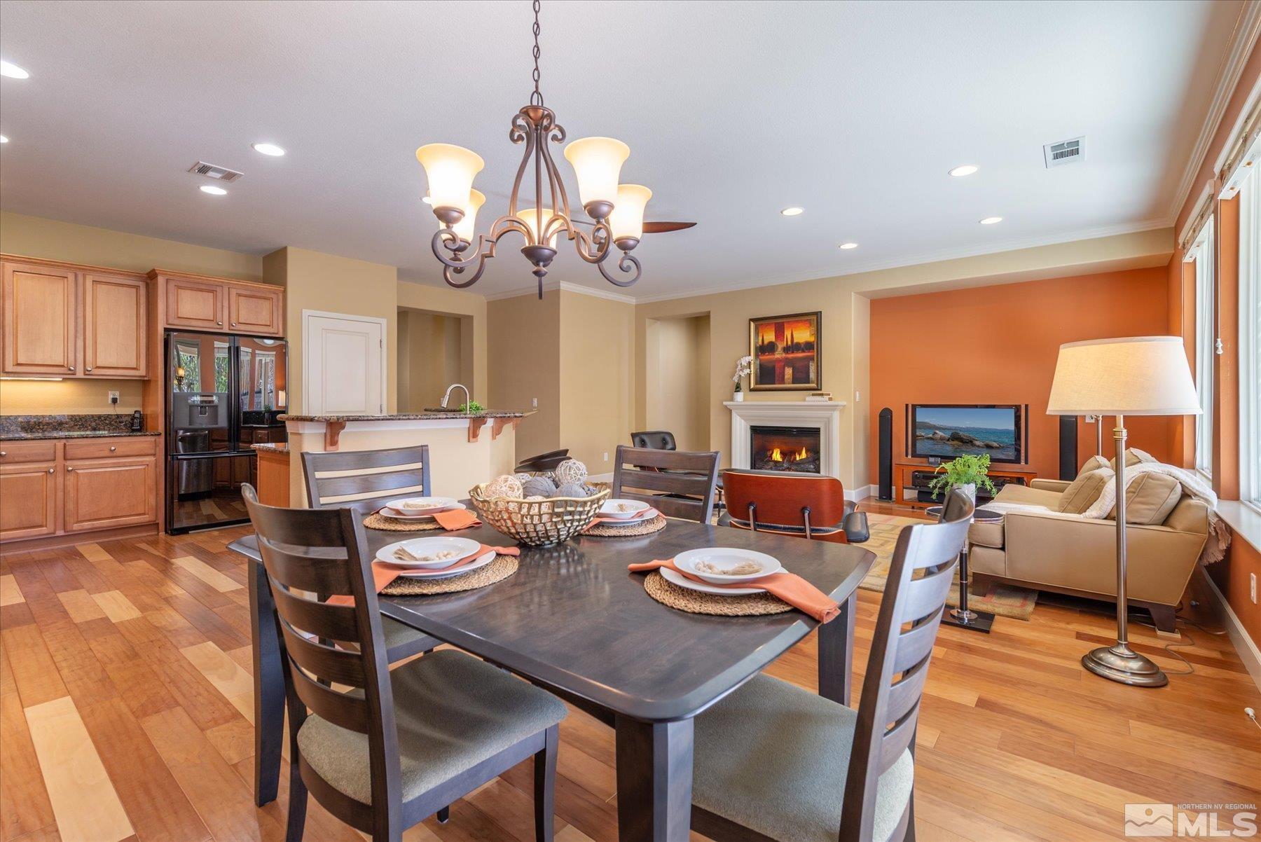 1375 Walking Stick Way Reno, NV 89523 - Photo 13 of 39 a view of a dining room with furniture a chandelier and wooden floor