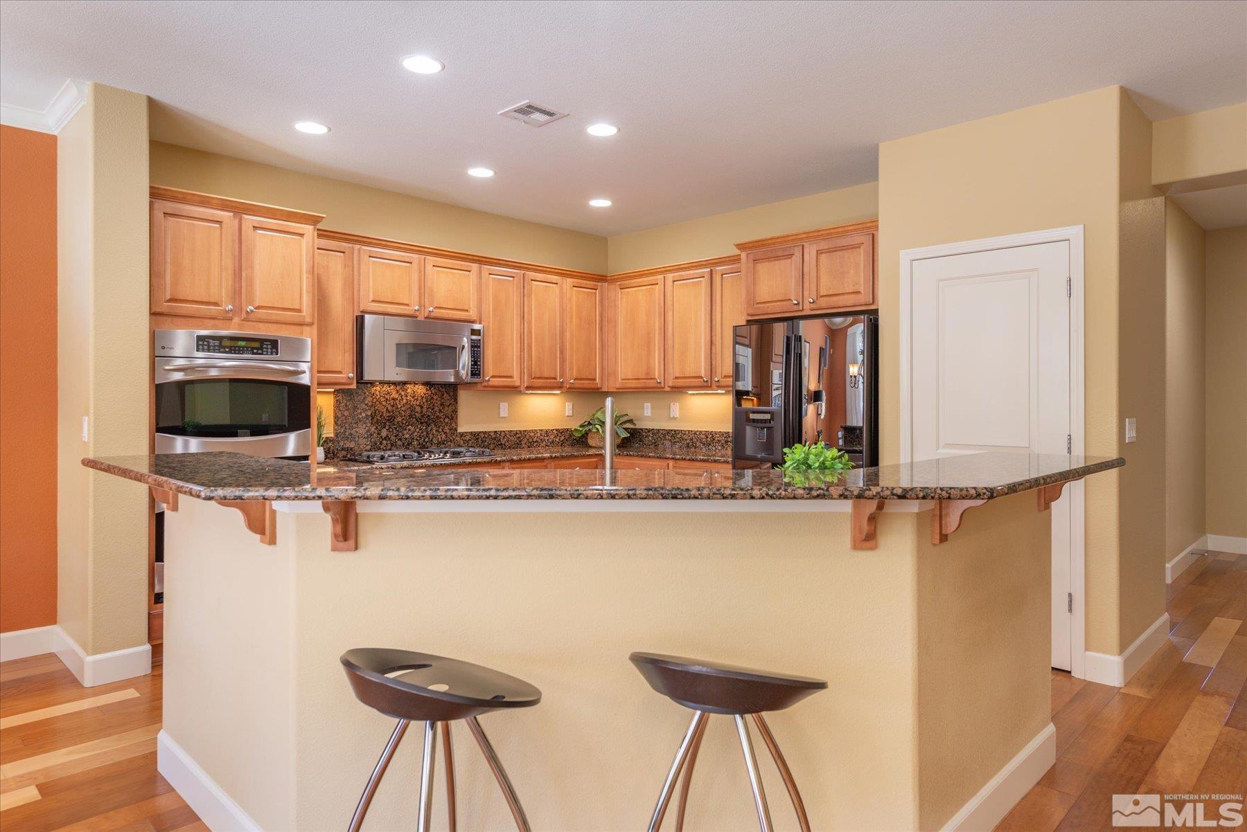1375 Walking Stick Way Reno, NV 89523 - Photo 14 of 39 a kitchen with stainless steel appliances granite countertop a sink and a refrigerator
