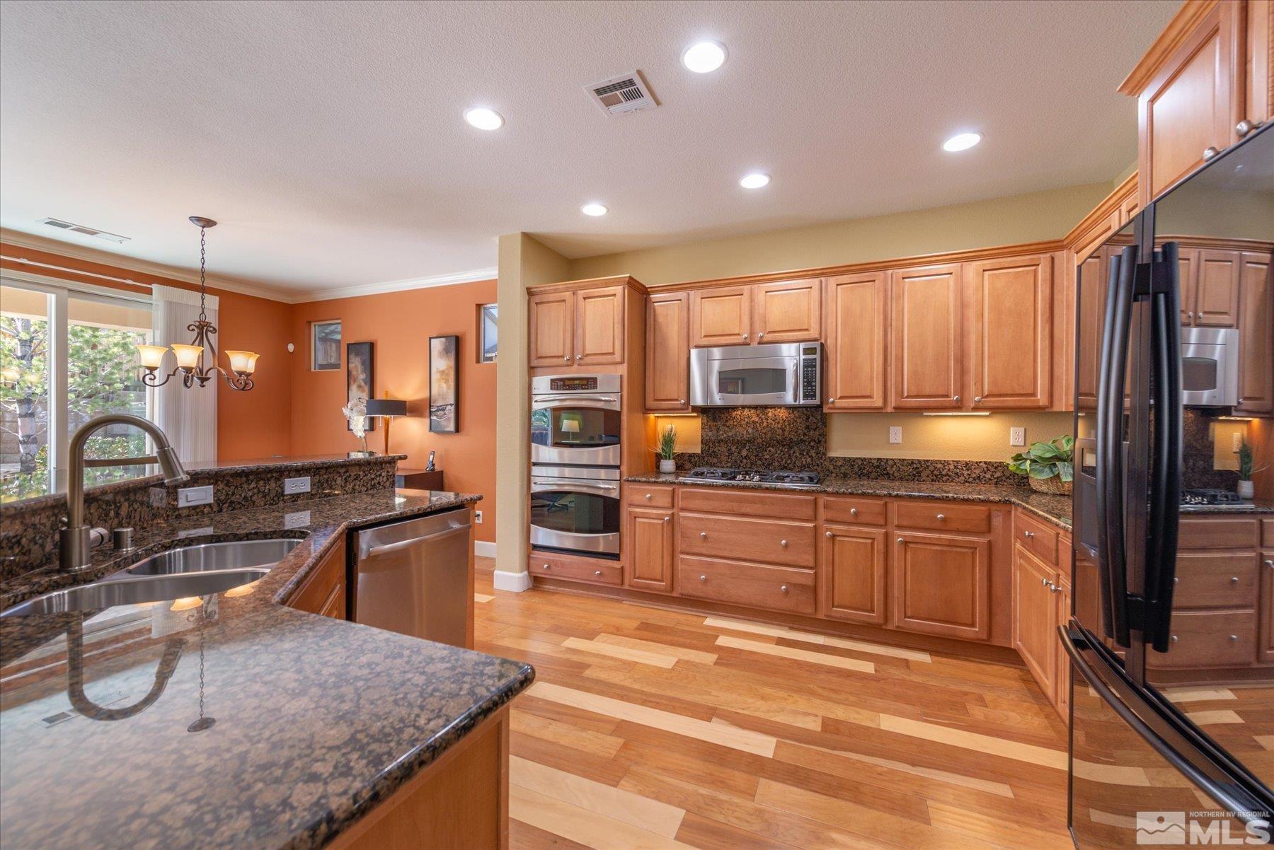 1375 Walking Stick Way Reno, NV 89523 - Photo 15 of 39 a kitchen with stainless steel appliances granite countertop a sink stove and refrigerator
