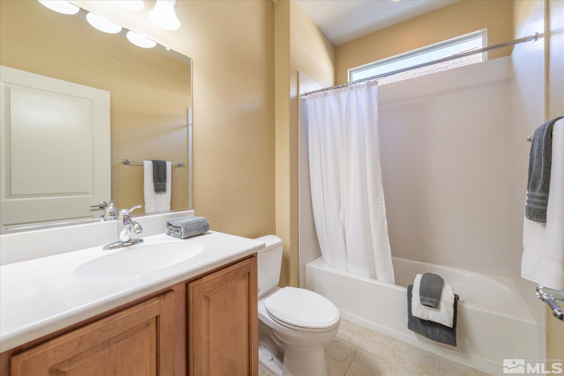 1375 Walking Stick Way Reno, NV 89523 - Photo 22 of 39 a bathroom with a sink a toilet and a mirror